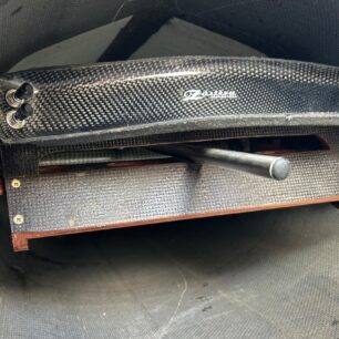 Pohled na opěrku nohou, karbonovou zpětnou opěrku a ovládání kormidla.